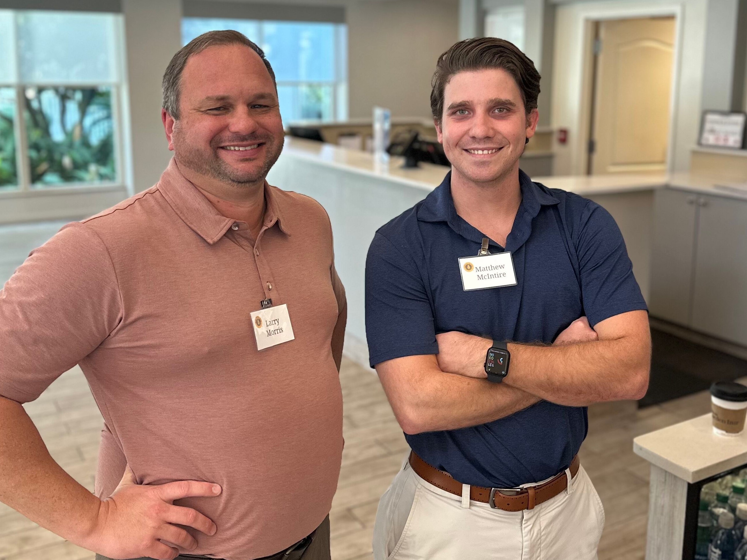 Two Sales Team Members Posing Together at Training