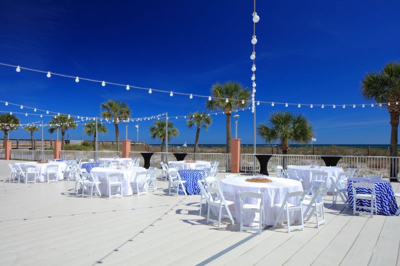 outdoor venue on beachy deck with round tables